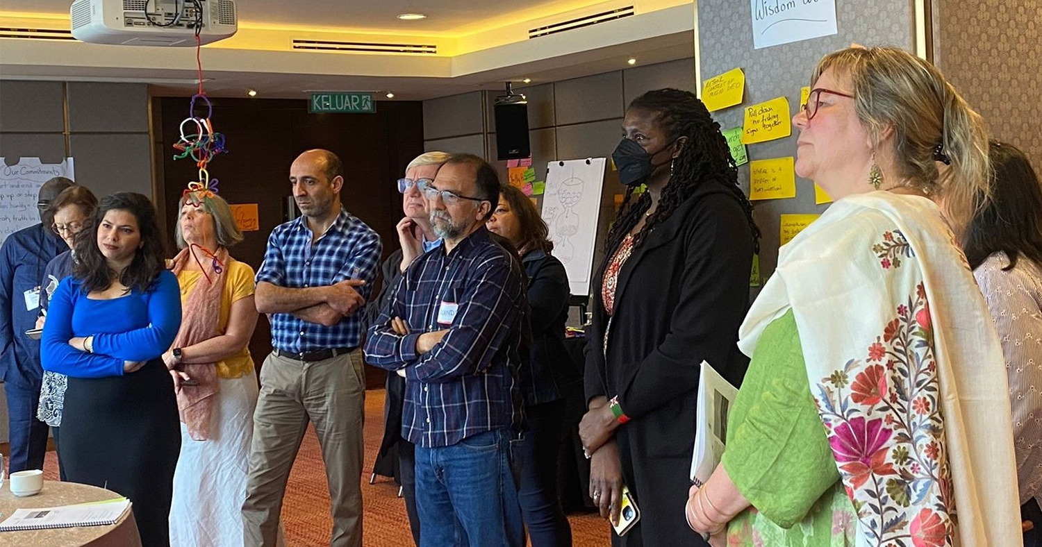 Participants in front of wisdom wall, March 2023.