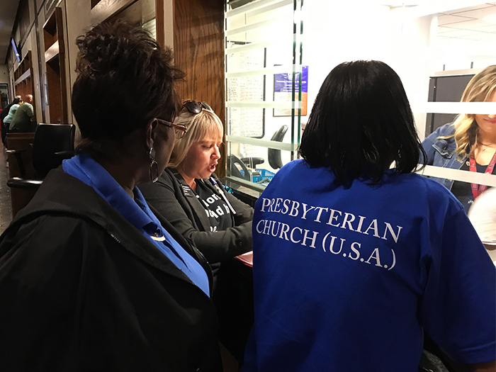 Holly McGlawn-Zoller of The Bail Project, center, is joined by Emma F. Jackson, left, and Bridgette Lewis, right, to pay bail on more than 50 people being detained in Louisville because they didn’t have the cash themselves. Working with the three women is Kasie Mason at right, supervisor in the office of the Jefferson County Circuit Court Clerk. (Photo by Tammy Warren)