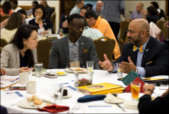 Sera Chung and Samuel Yenn-Batah speak with presenter Victor Aloyo Jr. (right) at the Presbyterian Intercultural Luncheon. 