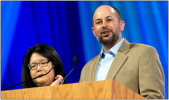 Richard Williams, coordinator of the YAV program, and YAV staff associate Lydia Kim address the assembly. 