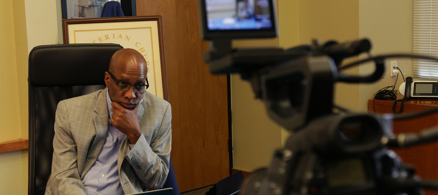 The Reverend Dr. J. Herbert Nelson, II, monitors the Leaders Briefing from the Presbyterian Center in Louisville. Photo by Randy Hobson.