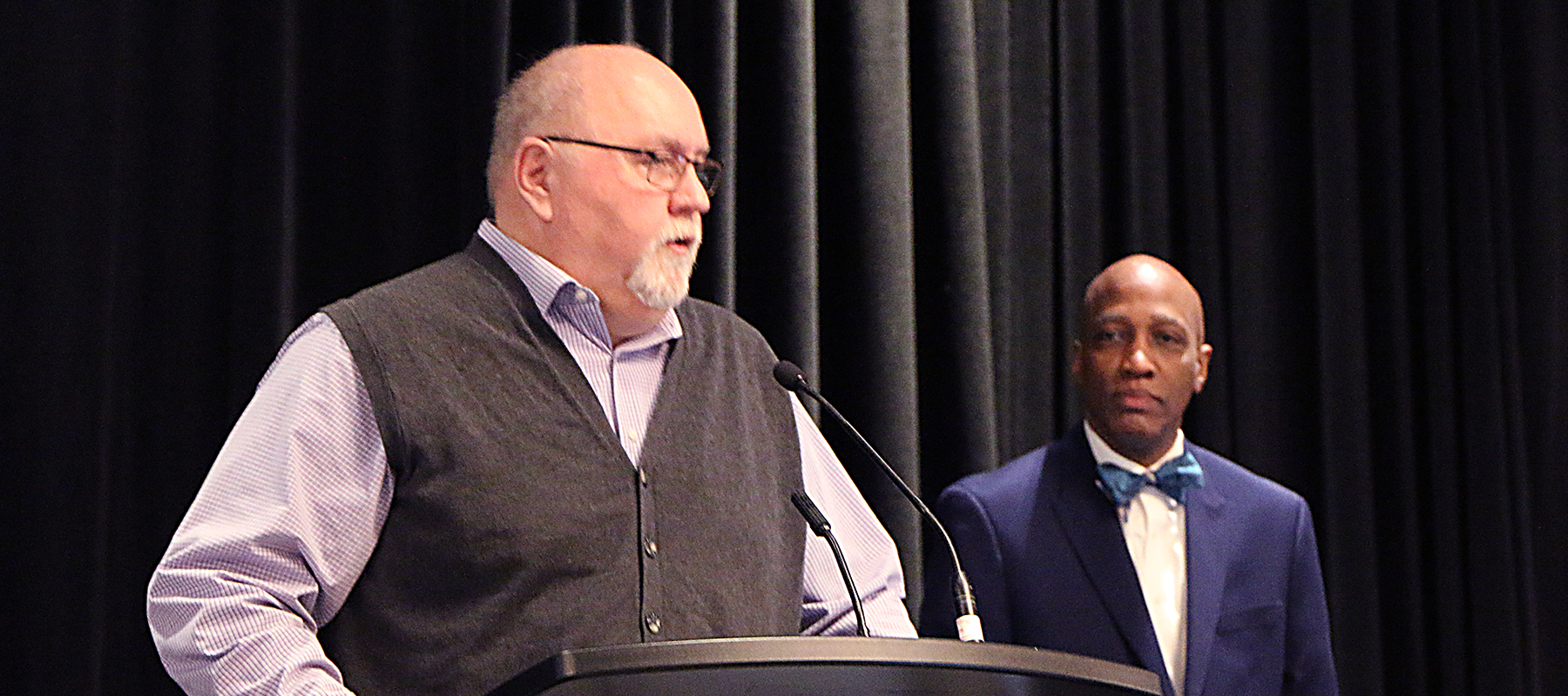 Kerry Rice (left) Deputy Stated Clerk of OGA, and the Rev. Dr. J. Herbert Nelson, II, Stated Clerk of the General Assembly of the OGA, speak to Mid Council leaders about per capita. 