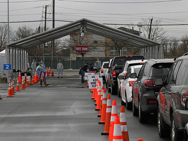 Vehicles line up for sample collection at the drive-thru COVID-19 Mobile Testing Center located at the South Beach Behavioral Center, Staten Island, Mar. 19, 2020. Members of the Army and Air National Guard provide additional administrative and medical support to the medical profession during Operation COVID-19. (U.S. Air National Guard photo by Maj. Patrick Cordova.)