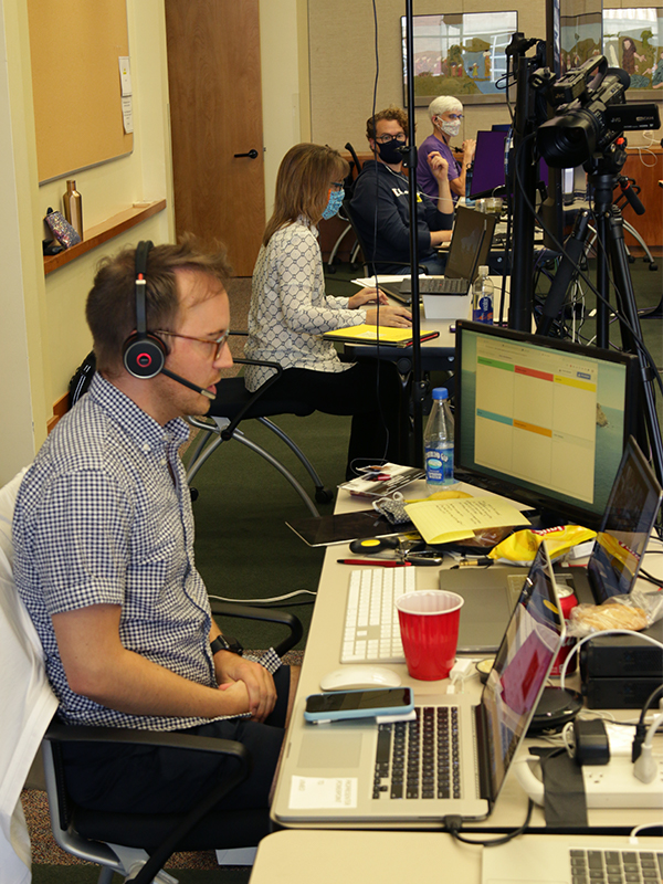 Producer Nathan Young keeps track of activity during the briefing. Photo by Randy Hobson.