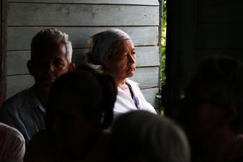 Worshipers crowd into the small living room that serves as the sanctuary for Presbyterian Mission at Marcane.