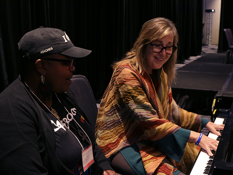 The Reverend Aisha Brooks-Lytle (left) and Tracy Keenan harmonize to Keenan’s new song. Photo by Rick Jones.