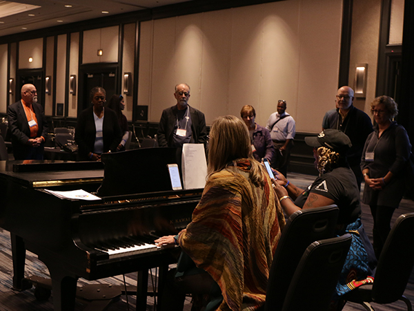 Musician Tracy Keenan plays a song she wrote utilizing the 2020 Vision Team’s proposed Guiding Statement, for several mid council leaders. Photo by Rick Jones.